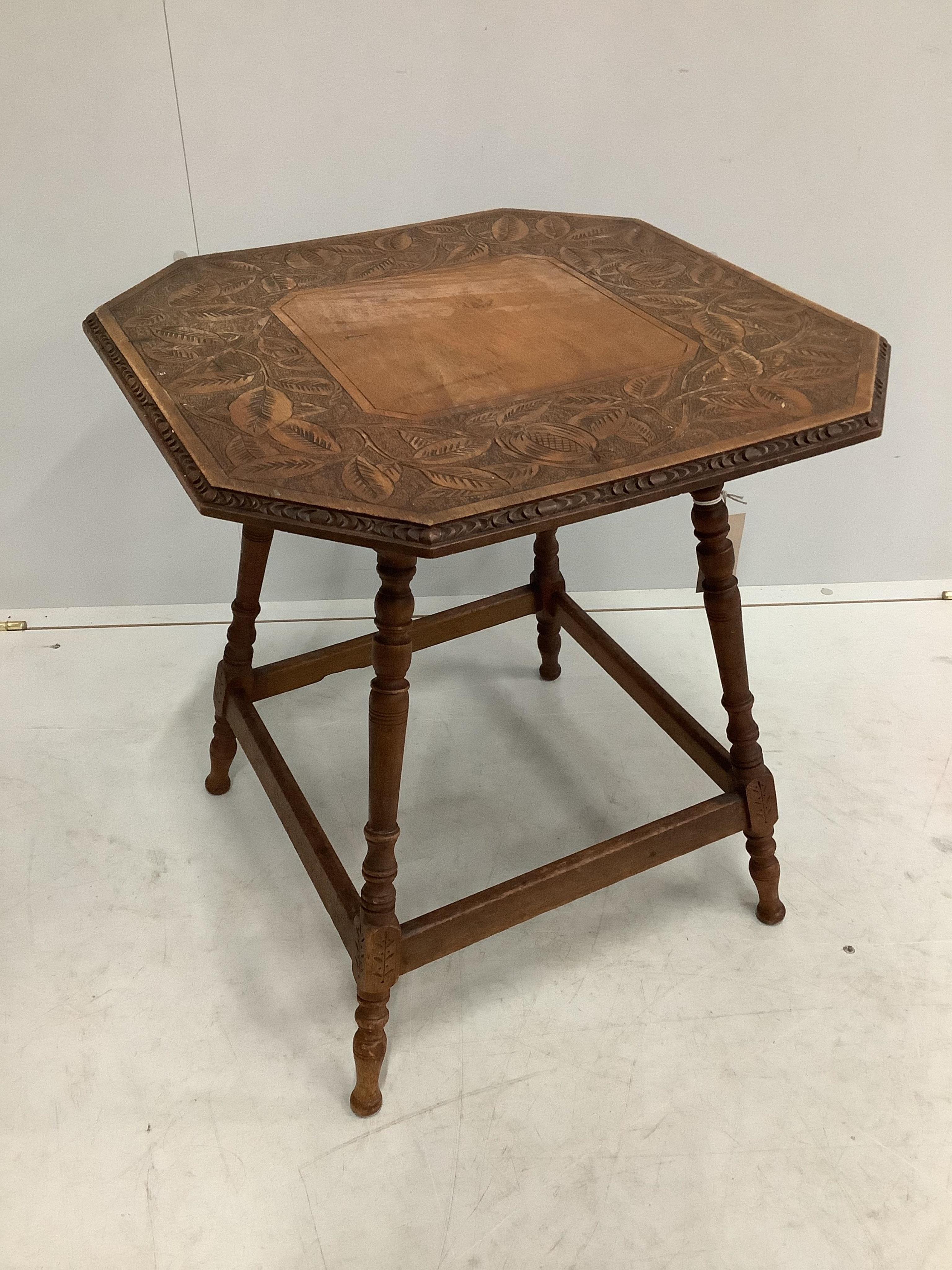 An early 20th century octagonal pokerwork occasional table, width 53cm, height 57cm